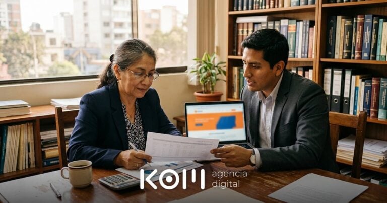 Dos abogados revisan un presupuesto impreso y una laptop para calcular cuánto cuesta la página web para abogados de su estudio
